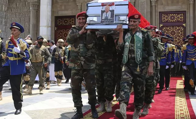 Houthi officers carry the coffin of Houthi Prime Minister Ahmed al-Rahawi, who was killed along with others in Israeli airstrikes on Thursday, out of the Shaab Mosque during his funeral in Sanaa, Yemen, Monday, Sept. 1, 2025. (AP Photo/Osamah Abdulrahman)