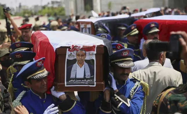 Honor guards carry the coffin of Houthi Minister of Culture and Tourism Ali al-Yafei, and the coffins of other officials killed in Israeli airstrikes on Thursday, during a funeral ceremony at the Shaab Mosque in Sanaa, Yemen, Monday, Sept. 1, 2025. (AP Photo/Osamah Abdulrahman)