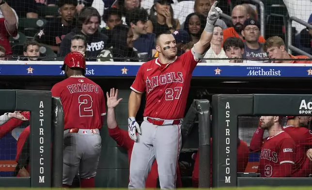 Los Angeles Angels designated hitter Mike Trout (27) celebrates after Logan O'Hoppe and Luis Rengifo scored off of a single by Oswald Peraza during the ninth inning of a baseball game against the Houston Astros in Houston, Saturday, Aug. 30, 2025. (AP Photo/Ashley Landis)