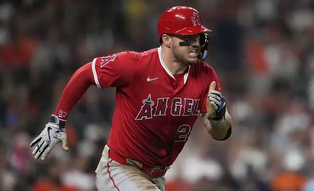 Los Angeles Angels designated hitter Mike Trout runs to first as he grounds out during the third inning of a baseball game against the Houston Astros in Houston, Sunday, Aug. 31, 2025. (AP Photo/Ashley Landis)