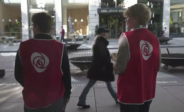 Campaign volunteers from the Labour Party stand on the sidewalk looking for people to engage with in Oslo, Sunday, Sept. 7, 2025. (AP Photo/Kostya Manenkov)