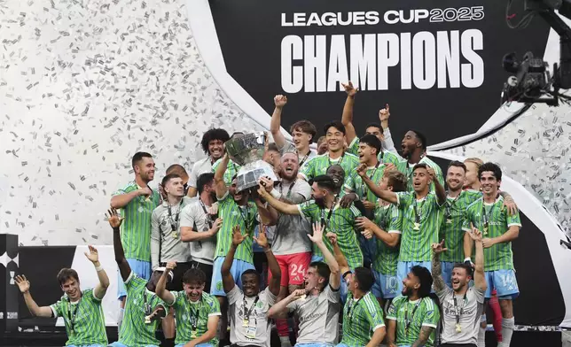 The Seattle Sounders lift the trophy as they celebrate beating Inter Miami in a Leagues Cup final soccer match Sunday, Aug. 31, 2025, in Seattle. (AP Photo/Lindsey Wasson)