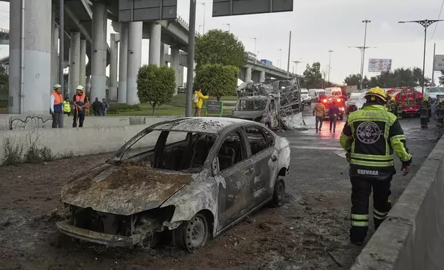 A burned car sits below an underpass following a gas tanker explosion in Mexico City, Wednesday, Sept. 10, 2025. (AP Photo/Fernando Llano)