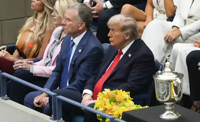 President Donald Trump, right, Steve Witkoff, center, and U.S. Attorney General, Pam Bondi, watch play between Carlos Alcaraz, of Spain, and Jannik Sinner, of Italy, during the men's singles final of the U.S. Open tennis championships, Sunday, Sept. 7, 2025, in New York. (AP Photo/Yuki Iwamura)