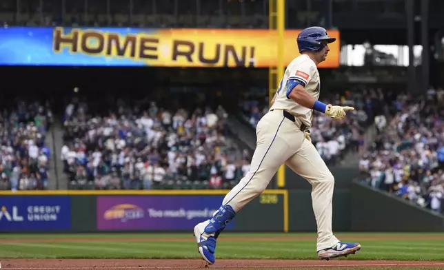 Seattle Mariners' Cal Raleigh jogs the bases after hitting his 54th home run of the season, a two-run home run to tie Mickey Mantle for most home runs by a switch-hitter in a single season, against the Los Angeles Angels during the first inning of a baseball game Sunday, Sept. 14, 2025, in Seattle. (AP Photo/Lindsey Wasson)