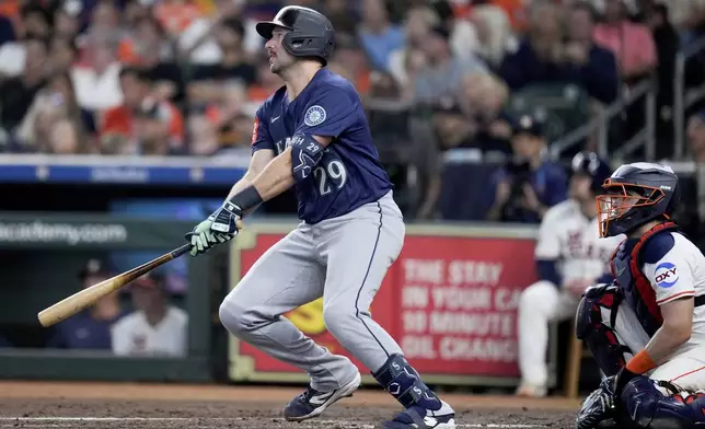 Seattle Mariners' Cal Raleigh (29) watches his solo home run against the Houston Astros during the third inning of a baseball game Saturday, Sept. 20, 2025, in Houston. (AP Photo/Eric Christian Smith)