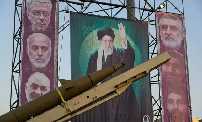 A domestically-built missile "Khaibar-buster," and banners showing portraits of the Iranian Supreme Leader Ayatollah Ali Khamenei, center, and the late armed forces commanders, who were killed in Israeli strike in June, are displayed in a military exhibition commemorating the anniversary of the start of the 1980-88 Iraq-Iran war, and 12-day war with Israel in June, at Baharestan Square, in Tehran, Thursday, Sept. 25, 2025. (AP Photo/Vahid Salemi)