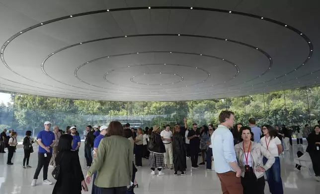Attendees wait inside the Steve Jobs Theater for an announcement of new products at Apple Park on Tuesday, Sept. 9, 2025, in Cupertino, Calif. (AP Photo/Godofredo A. Vásquez)