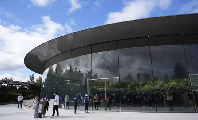 Attendees arrive at the Steve Jobs Theater for an announcement of new products at Apple Park on Tuesday, Sept. 9, 2025, in Cupertino, Calif. (AP Photo/Godofredo A. Vásquez)