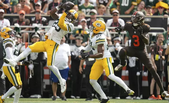 Green Bay Packers' Xavier McKinney intercepts a pass in front of Cleveland Browns' Jerry Jeudy during the first half of an NFL football game Sunday, Sept. 21, 2025, in Cleveland. (AP Photo/Sue Ogrocki)