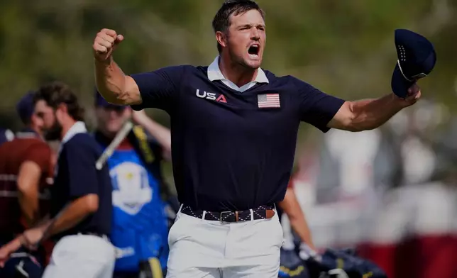 United States' Bryson DeChambeau celebrates after their match win at Bethpage Black golf course during the Ryder Cup golf tournament, Saturday, Sept. 27, 2025, in Farmingdale, N.Y. (AP Photo/Matt Slocum)