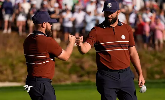 Europe's Tyrrell Hatton celebrates with Jon Rahm on the sixth hole at Bethpage Black golf course during the Ryder Cup golf tournament, Saturday, Sept. 27, 2025, in Farmingdale, N.Y. (AP Photo/Robert Bukaty)