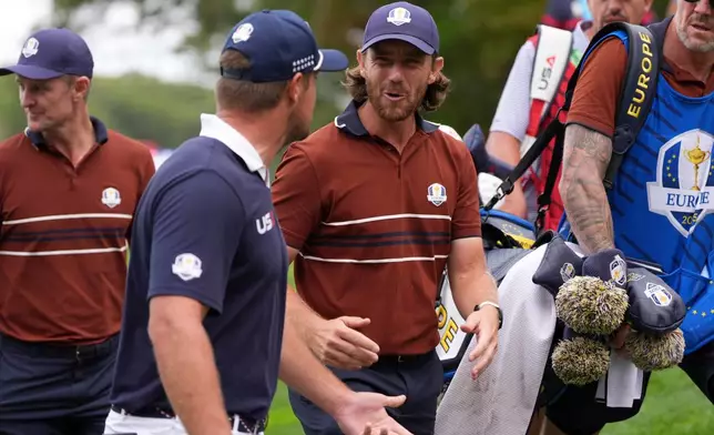 United States' Bryson DeChambeau and Europe's Tommy Fleetwood talk on the way to the on the 16th tee at Bethpage Black golf course during the Ryder Cup golf tournament, Saturday, Sept. 27, 2025, in Farmingdale, N.Y. (AP Photo/Lindsey Wasson)