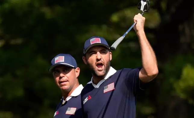 United States' Scottie Scheffler celebrates after a putt on the 13th hole at Bethpage Black golf course during the Ryder Cup golf tournament, Saturday, Sept. 27, 2025, in Farmingdale, N.Y. (AP Photo/Seth Wenig)