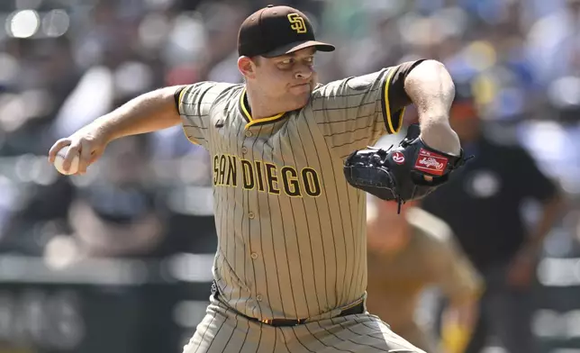 San Diego Padres starter Michael King delivers a pitch during the first inning of a baseball game against the Chicago White Sox, Sunday, Sept. 21, 2025, in Chicago. (AP Photo/Paul Beaty)