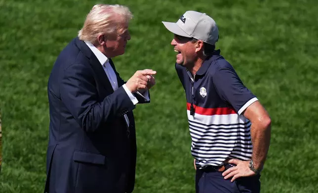 President Donald Trump greets United States team captain Keegan Bradley on the first hole at Bethpage Black golf course during the Ryder Cup golf tournament, Friday, Sept. 26, 2025, in Farmingdale, N.Y. (AP Photo/Seth Wenig)