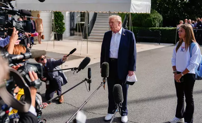 Kai Trump watches as her grandfather President Donald Trump speaks to reporters before departing the White House, Friday, Sept. 26, 2025, in Washington. (AP Photo/Julia Demaree Nikhinson)