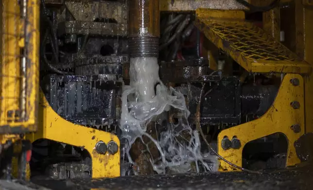 Residual water gushes from the Expedition 501 wireline core drilling rig during an operation aboard the Liftboat Robert platform, in the North Atlantic, Sunday, July 20, 2025. (AP Photo/Carolyn Kaster)