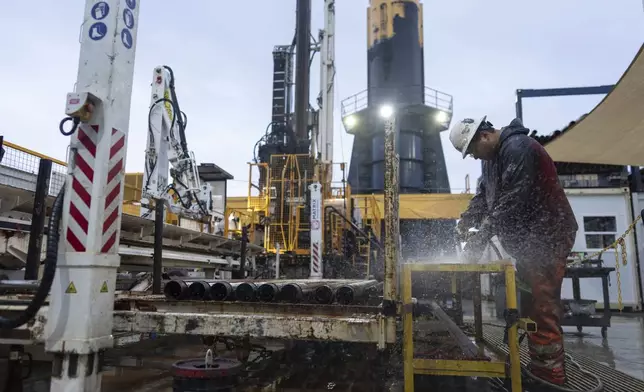 Drilling team member Lalo Aguilar works on inner tubes during an Expedition 501 wireline core drilling operation aboard the Liftboat Robert platform, in the North Atlantic, Sunday, July 20, 2025. (AP Photo/Carolyn Kaster)