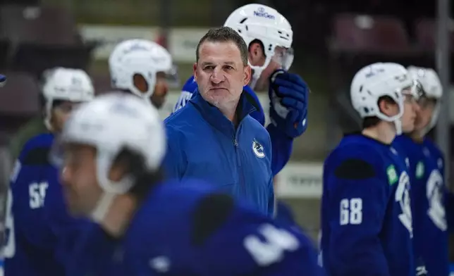 Vancouver Canucks head coach Adam Foote looks on during opening day of the NHL hockey team's training camp in Penticton, British Columbia, Thursday, Sept. 18, 2025. (Darryl Dyck/The Canadian Press via AP)