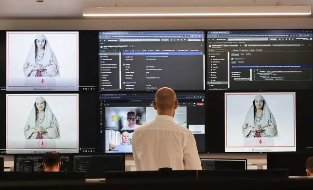 Albanian experts work at the National Agency for Information Society as an artificial intelligence "minister" Diella, whose name means "Sun" in Albanian, is seen on the screens in Tirana, Albania, Friday, Sept. 12, 2025. (AP Photo/Vlasov Sulaj)