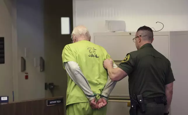 Orange County Superior Court Judge Jeffrey Ferguson is removed from court after being sentenced to 35 years to life in prison after his second-degree murder conviction for shooting his wife following an hours-long argument at the Central Justice Center in Santa Ana, Calif. Wednesday, Sept. 17, 2025. (Allen J. Schaben/Los Angeles Times via AP, Pool)