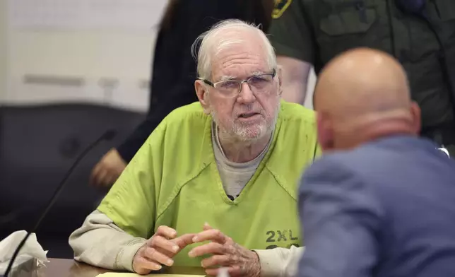 Orange County Superior Court Judge Jeffrey Ferguson listens to his lawyers as he is sentenced to 35 years to life in prison after his second-degree murder conviction for shooting his wife following an hours-long argument at the Central Justice Center in Santa Ana, Calif., Wednesday, Sept. 17, 2025. (Allen J. Schaben/Los Angeles Times via AP, Pool)