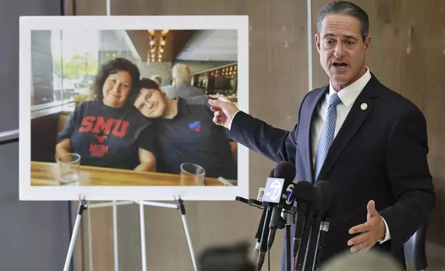 A photo of Sheryl Ferguson, the wife and son Phillip Ferguson of Orange County Superior Judge Jeffrey Ferguson is displayed as Orange County District Attorney Todd Spitzer speaks to the media after Orange County Superior Court Judge Jeffrey Ferguson was sentenced to 35 years to life in prison after his second-degree murder conviction for shooting his wife following an argument at the Central Justice Center in Santa Ana, Calif., Wednesday, Sept. 17, 2025. (Allen J. Schaben/Los Angeles Times via AP, Pool)