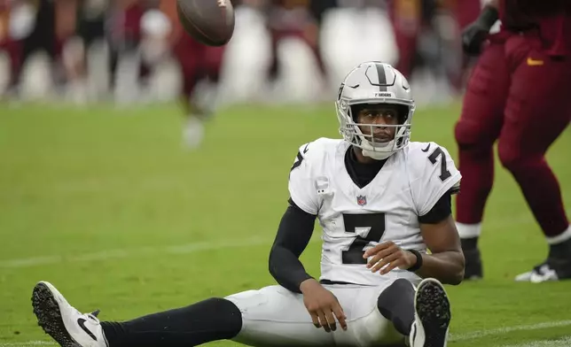 Las Vegas Raiders quarterback Geno Smith (7) reacts after being sacked during the second half of NFL football game against the Washington Commanders, Sunday, Sept. 21, 2025, in Landover, Md. (AP Photo/Stephanie Scarbrough)