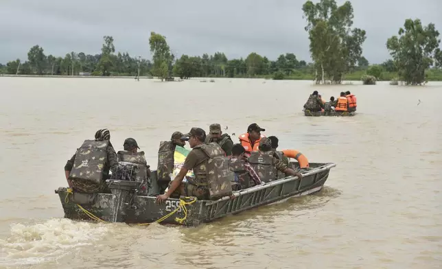 Indian army soldiers travel in boats through floodwaters to rescue the stranded people following heavy rains in Kapurthala district of northern state of Punjab, India, Tuesday, Sept. 2, 2025. (AP Photo/Prabhjot Gill)