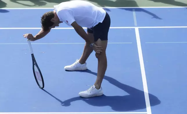 Co-creator of the Laver Cup Roger Federer reacts after Team Europe captain Yannick Noah missed a shot while hitting tennis balls to local youth tennis players during a court unveiling at John McLaren Park Tennis Courts before the Laver Cup tennis matches in San Francisco, Tuesday, Sept. 16, 2025. (AP Photo/Jeff Chiu)