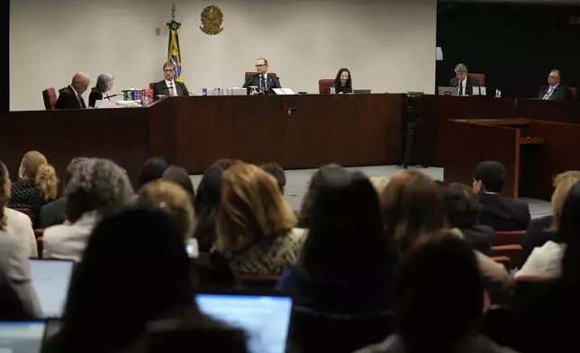 Justices of the Brazilian Supreme Court meet for the verdict and sentencing phase of a trial for those charged in an alleged coup plot to keep Brazil's former President Jair Bolsonaro in office after his 2022 election defeat, in Brasilia, Brazil, Thursday, Sept. 11, 2025. (AP Photo/Eraldo Peres)