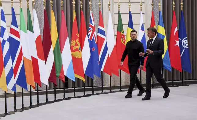 Ukraine's President Volodymyr Zelenskyy, left, and French President Emmanuel Macron, arrive to attend a summit on Ukraine at the Elysee Palace, in Paris, France, Thursday, Sept. 4, 2025. (Ludovic Marin/Pool Photo via AP)