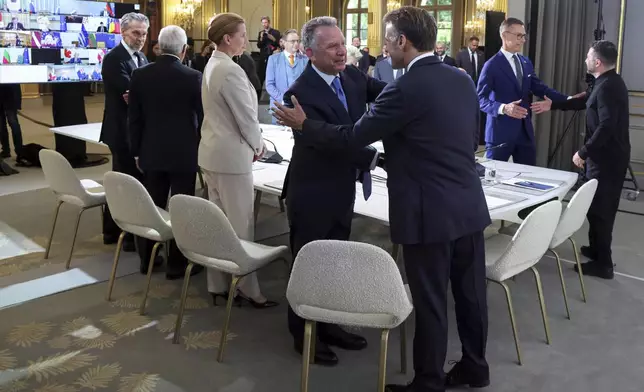 White House Special Envoy Steve Witkoff, center left, shakes hand with France's President Emmanuel Macron during a summit on Ukraine at the Elysee Palace, in Paris, France, Thursday, Sept. 4, 2025. (Ludovic Marin/Pool Photo via AP)