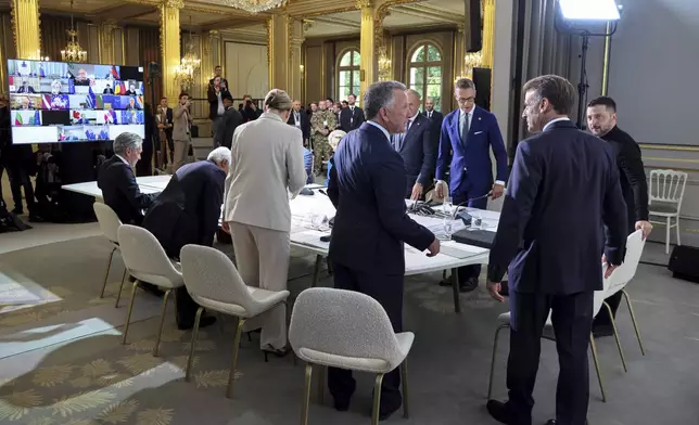White House Special Envoy Steve Witkoff, center with back to camera, speaks with France's President Emmanuel Macron, second from right, flanked by Ukraine's President Volodymyr Zelenskyy, right, during a summit on Ukraine at the Elysee Palace, in Paris, France, Thursday, Sept. 4, 2025. (Ludovic Marin/ Pool Photo via AP)