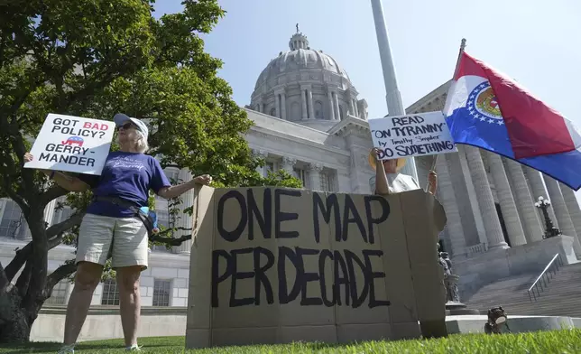 Robin Rothove, left, and Paula Smith, right, demonstrate outside the Missouri Capitol as lawmakers prepare to conduct a committee hearing inside to consider redrawing the state's U.S. House districts, Thursday, Sept. 4, 2025, in Jefferson City, Mo. (AP Photo/Jeff Roberson)
