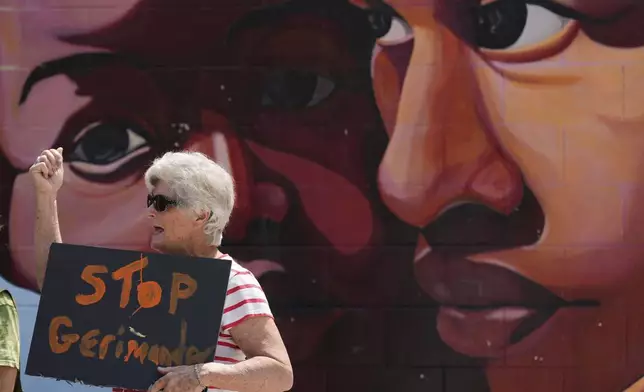 Barbara Cates protests during a rally by residents opposed to plans to redraw Missouri's congressional districts, Thursday, Sept. 4, 2025, in Kansas City, Mo. (AP Photo/Charlie Riedel)