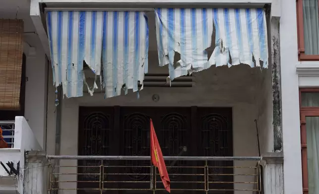 A Vietnamese national flag flies outside a balcony in the old quarter of Hanoi, Vietnam, Sunday, Aug. 31, 2025. (AP Photo/Vincent Thian)
