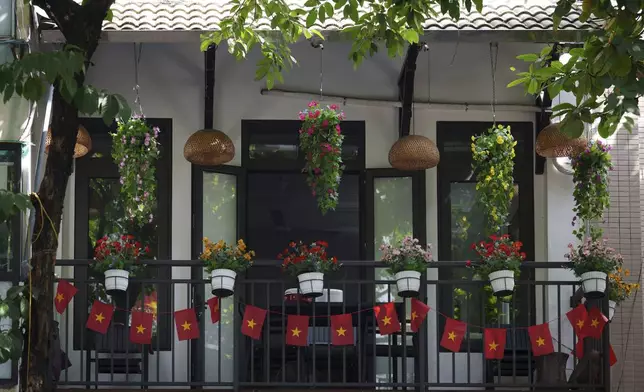 Vietnamese national flags decorate a balcony in the old quarter of Hanoi, Vietnam, Sunday, Aug. 31, 2025. (AP Photo/Vincent Thian)