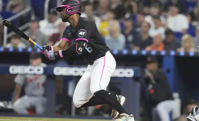 Miami Marlins' Otto Lopez (6) follows through on a RBI single to score Agustin Ramirez during the first inning of a baseball game against the Detroit Tigers, Saturday, Sept. 13, 2025, in Miami. (AP Photo/Lynne Sladky)