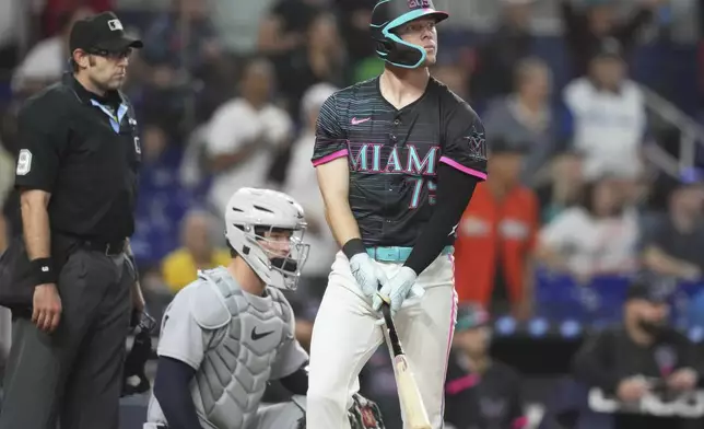 Miami Marlins' Troy Johnston, right, watches after hitting a walk-off two run home run during the 11th inning of a baseball game against the Detroit Tigers, Saturday, Sept. 13, 2025, in Miami. (AP Photo/Lynne Sladky)