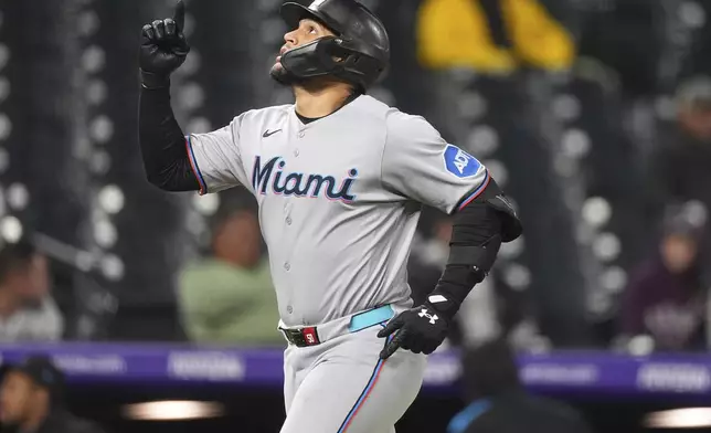 Miami Marlins' Agustín Ramírez gestures as he circles the bases after hitting a two-run home run off Colorado Rockies relief pitcher Roansy Contreras in the eighth inning of a baseball game Wednesday, Sept. 17, 2025, in Denver. (AP Photo/David Zalubowski)