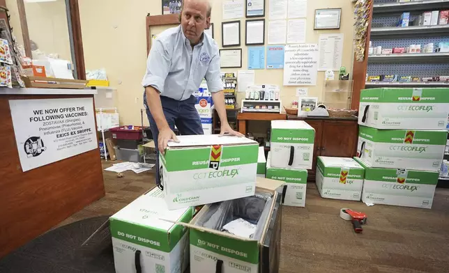 Co-owner Eric Abramowitz at Eric's Rx Shoppe unpacks a shipment of COVID-19 vaccines at the store in Horsham, Pa., Tuesday, Sept. 2, 2025. (AP Photo/Matt Rourke)