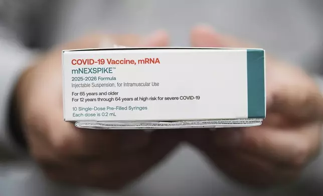 Co-owner Marc Ost at Eric's Rx Shoppe holds a box of COVID-19 vaccines as he unpacks a shipment in Horsham, Pa., Tuesday, Sept. 2, 2025. (AP Photo/Matt Rourke)