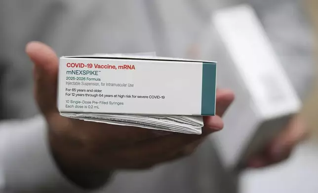 Co-owner Marc Ost at Eric's Rx Shoppe holds a box of COVID-19 vaccines as he unpacks a shipment in Horsham, Pa., Tuesday, Sept. 2, 2025. (AP Photo/Matt Rourke)