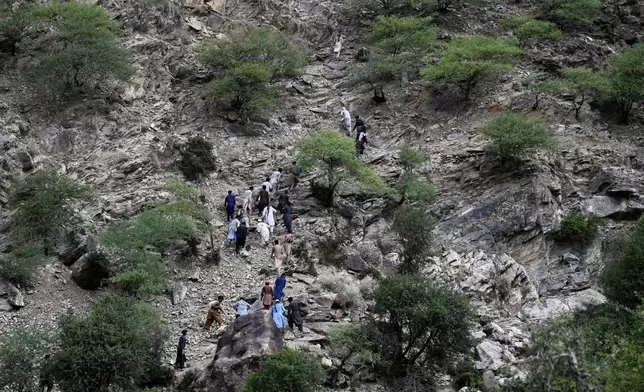 Residents from surrounding towns and villages climb as they try to reach the quake-hit region to assist survivors after Sunday night's powerful 6.0-magnitude earthquake that struck several provinces, in the Nurgol district, Kunar province, eastern Afghanistan, Tuesday, Sept. 2, 2025. (AP Photo/Nava Jamshidi)