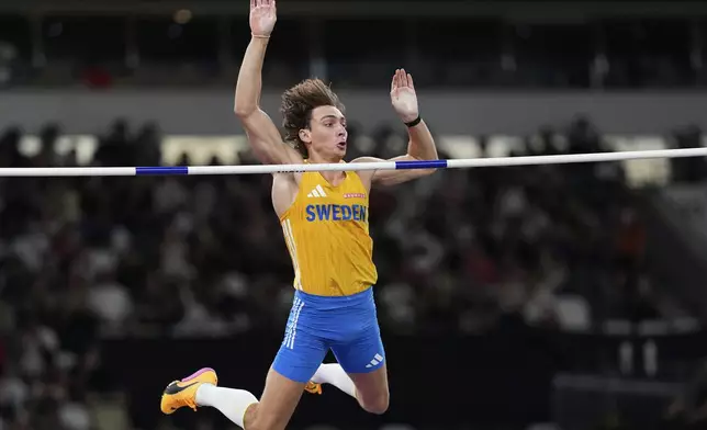 Sweden's Armand Duplantis clears the bar to set a new men's pole vault world record of 6.30 meters, at the World Athletics Championships in Tokyo, Monday, Sept. 15, 2025. (AP Photo/Matthias Schrader)