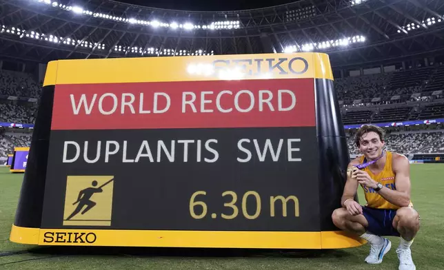 Sweden's Armand Duplantis poses after setting a new men's pole vault world record of 6.30 meters, at the World Athletics Championships in Tokyo, Monday, Sept. 15, 2025. (AP Photo/Matthias Schrader)