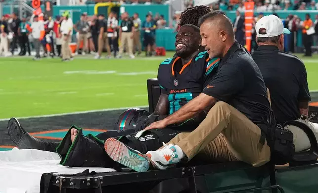 Miami Dolphins wide receiver Tyreek Hill (10) is carted off the field by staff after suffering an unknown injury in the second half of an NFL football game against the New York Jets, Monday, Sept. 29, 2025, in Miami Gardens, Fla. (AP Photo/Marta Lavandier)