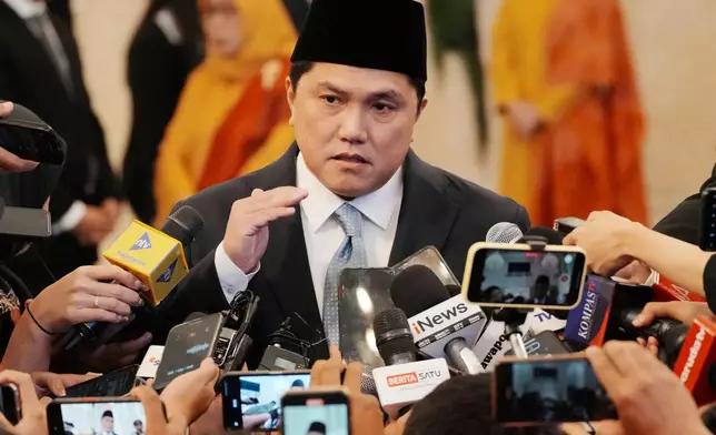 Indonesia's newly-appointed minister of youth and sports Erick Thohir talks to journalists after the swearing-in ceremony at the presidential palace in Jakarta, Indonesia, Wednesday, Sept. 17, 2025. (AP Photo/Achmad Ibrahim)